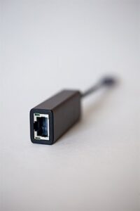 An image featuring a small ethernet adapter